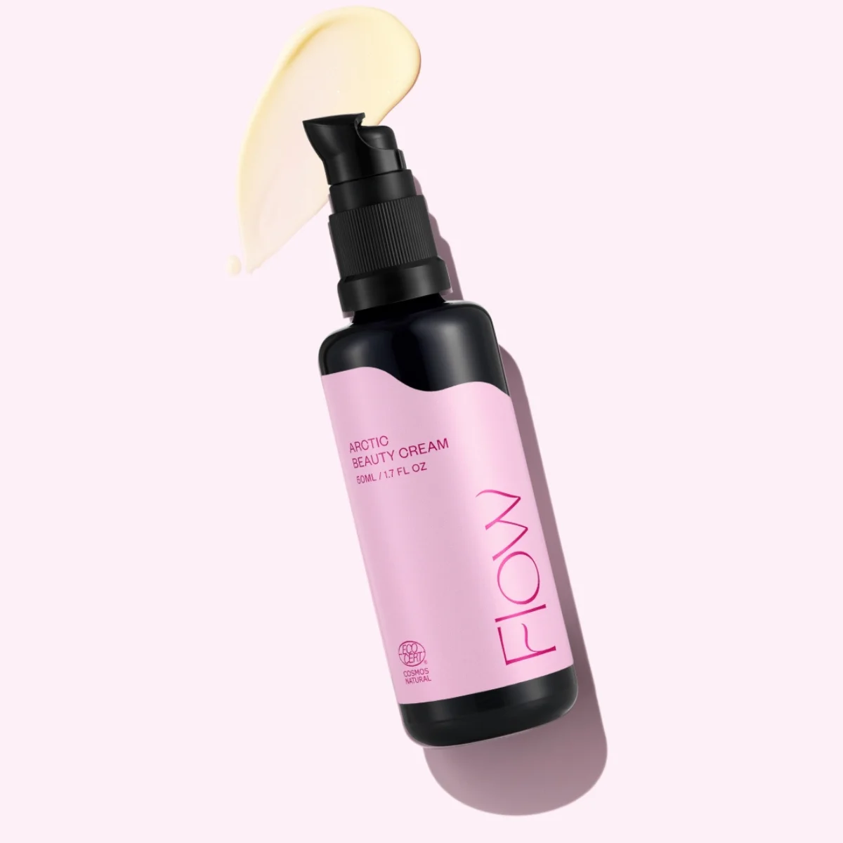 Pump bottle of Arctic Beauty Cream with a pink label on a light pink background, with a dab of cream smeared nearby.